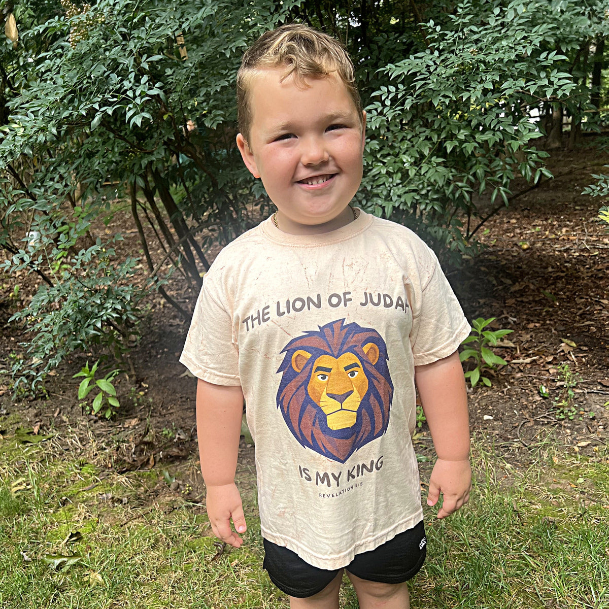 Child wearing The Lion of Judah Is My King youth tee in Umber