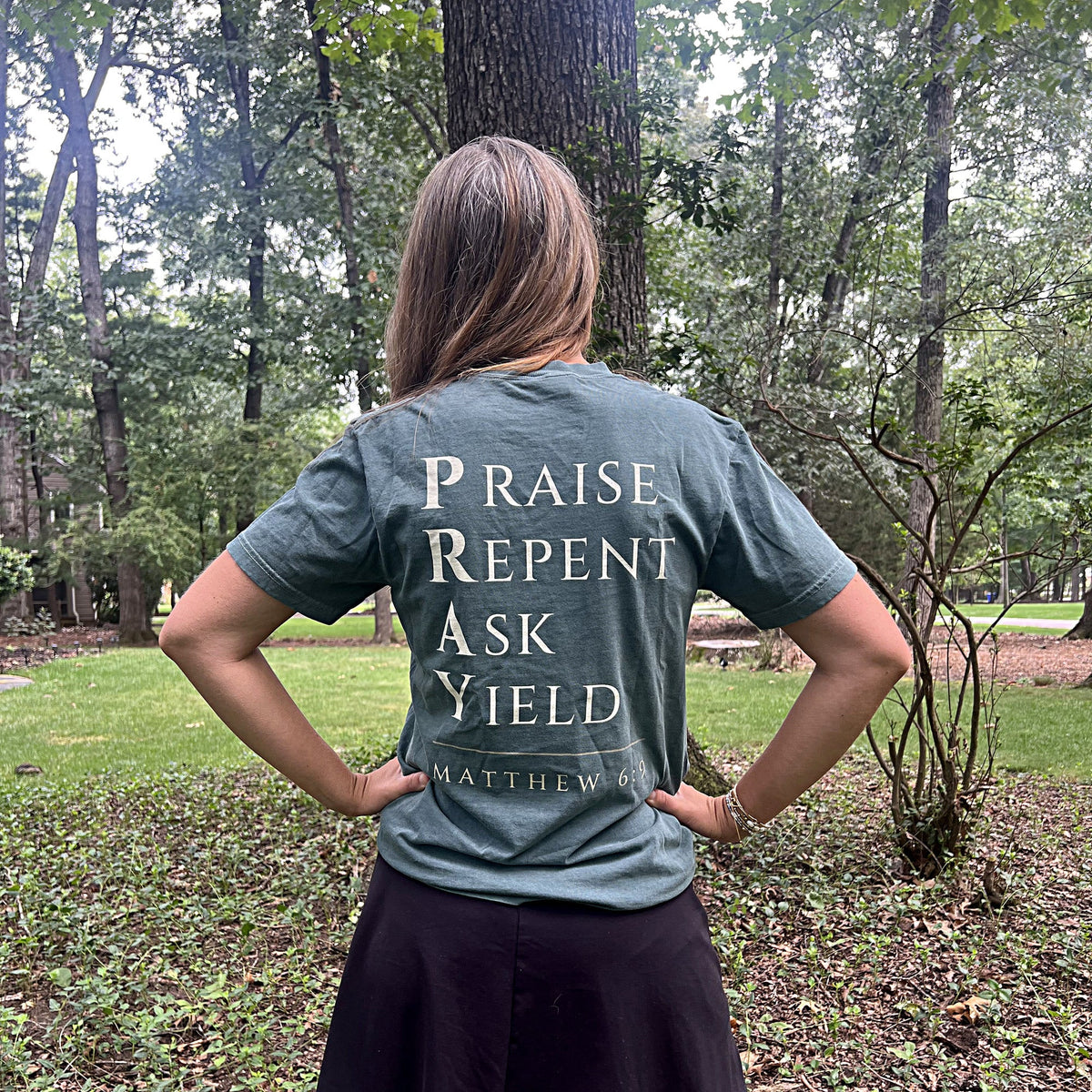 Back of the Pray tee showing the Praise Repent Ask Yield acrostic