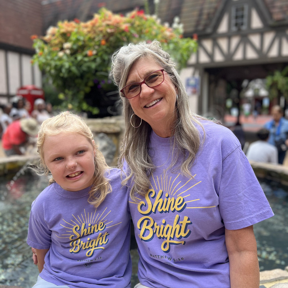 Adult and child in matching Shine Bright tees in Violet